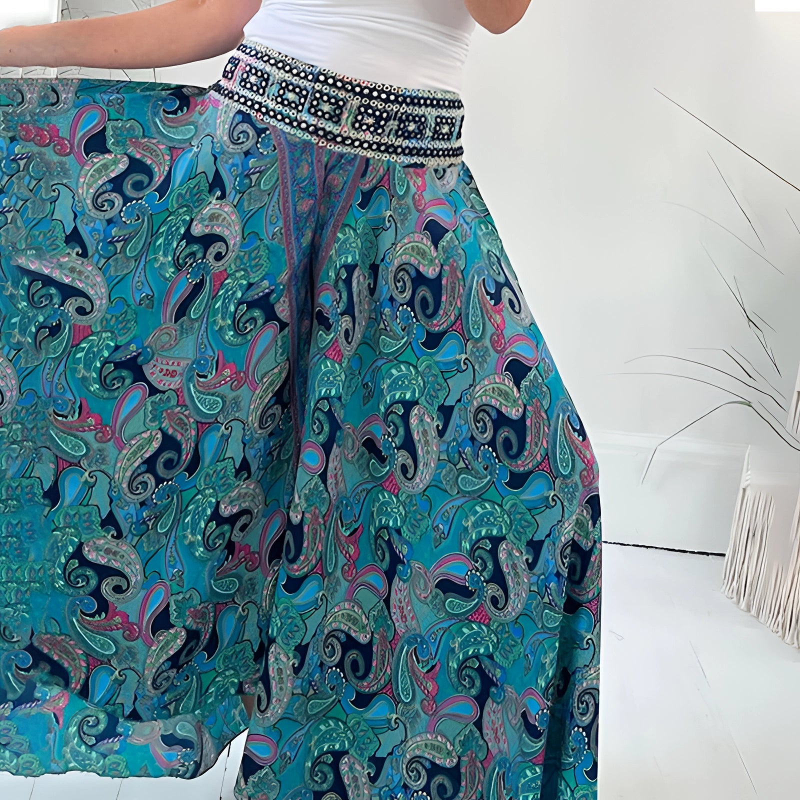 Bohemian Palazzo Pants in pink paisley print with wide-leg design and ethnic patterns, lightweight textile displayed on a hanger.