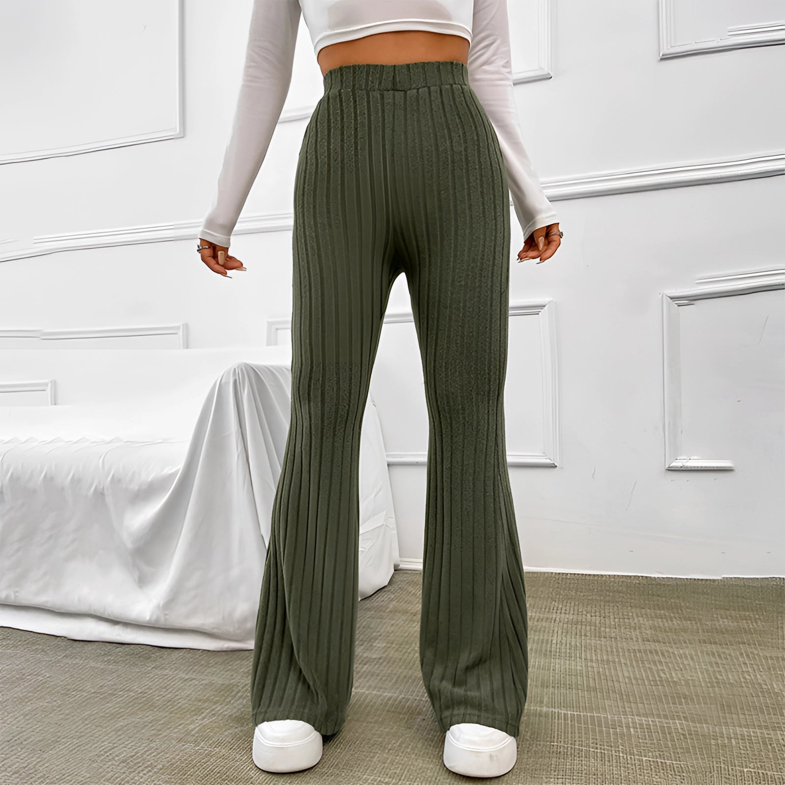 Olive green high waist ribbed flared pants with stretch bell bottoms, showcasing full leg view.