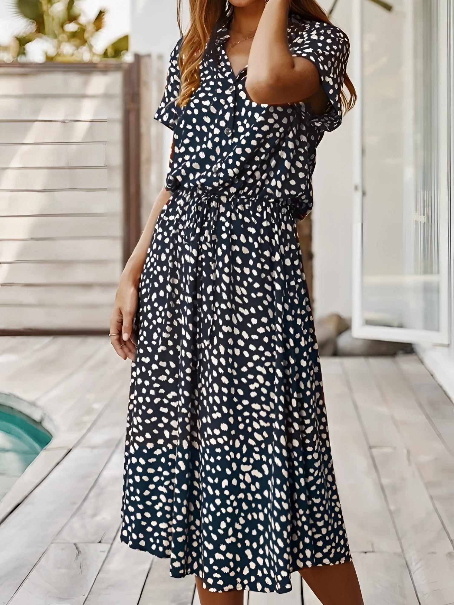 White polka dot midi dress with short sleeves and a tie waist, lightweight summer outfit.