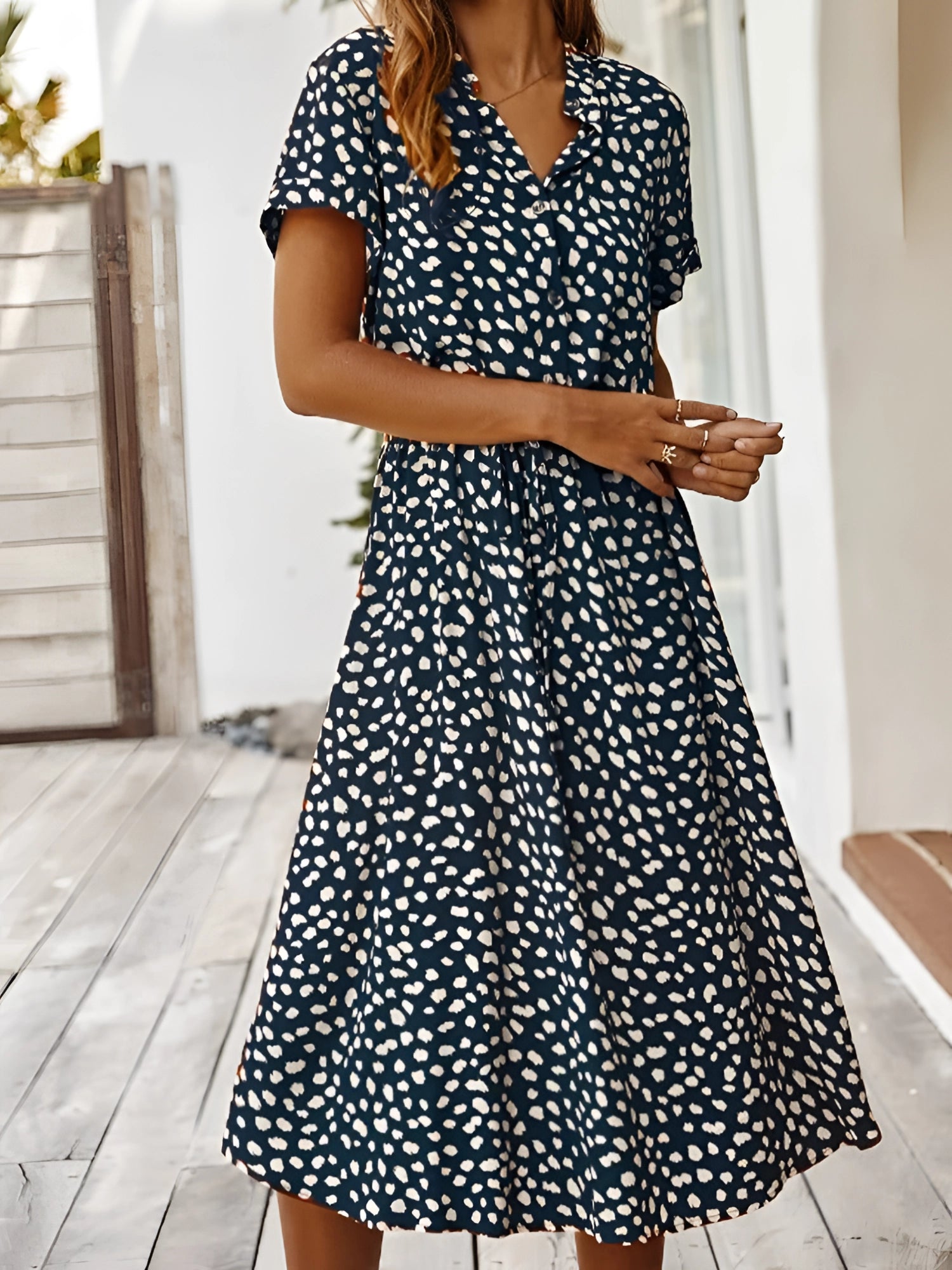 White polka dot midi dress with short sleeves, tie waist, and lightweight fabric, perfect for summer.