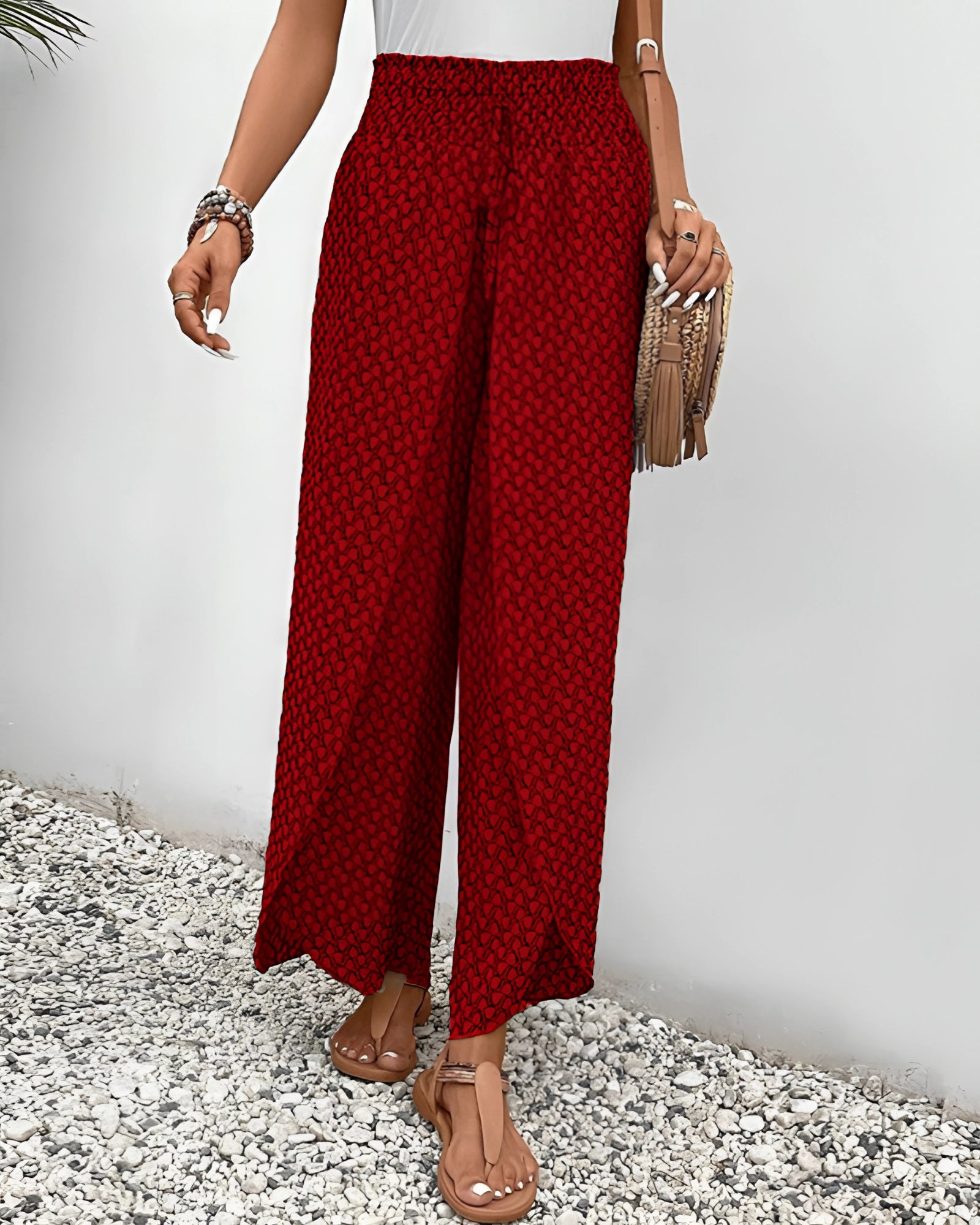 Red high-waisted palazzo pants with an ethnic pattern, featuring a boho style suitable for summer beachwear.